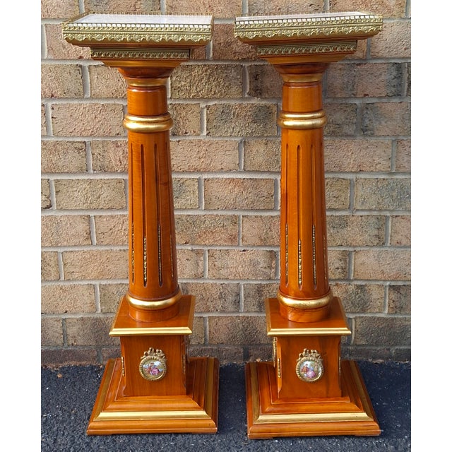 A pair of Neoclassical-style gilt-decorated mahogany and galleried marble top pedestals by Meroni Francesco for Versailles...