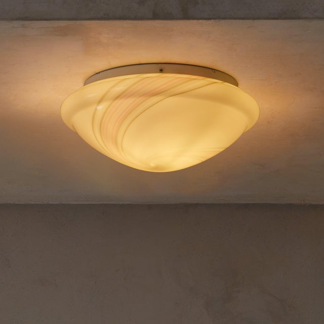 An Italian flush mount from the 1970s, crafted in hand-blown Murano glass with soft gray and rose tones swirling through...