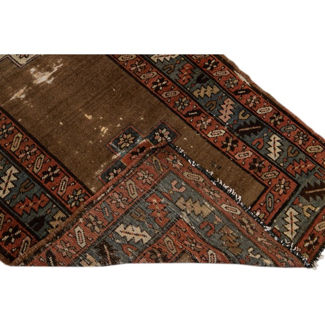 Beautiful Antique Serab hand-knotted distressed wool rug with the brown field and multicolor accents in all over geometric...