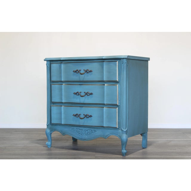 1970's solid built chest of drawers This chest is newly painted in light blue and gold with mate finish Dimensions:...