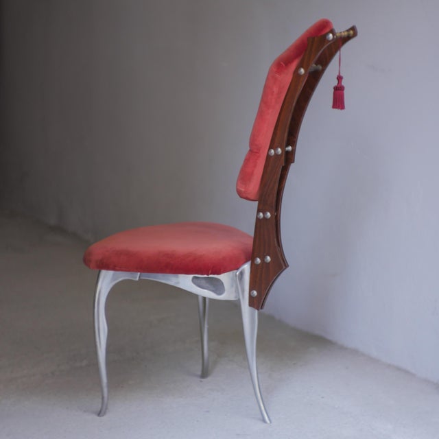 A rare chair designed by Toni Cordero and produced by Morphos. Made in Italy in the 1990s. Cast aluminum frame, velvet...