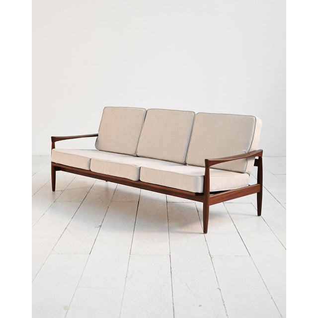 Solid teak frame with slatted backrest. Cushions reupholstered. Designed by Erik Wørtz, 1950s. Designed by Erik Wørtz in...