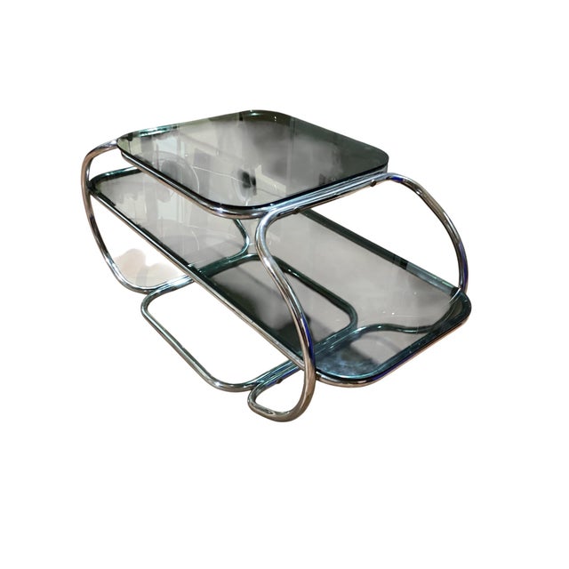 Italian designer coffee table with a chrome frame and smoked glass top from the 1960s. Its modern style and lines make it...