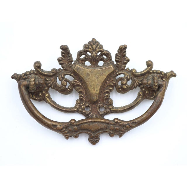 Victorian style dresser drawer pull made of brass with a patina finish. Mounting screws are included. Good condition with...