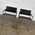 Handsome pair of chrome and black vinyl faux leather campaign style sling director’s chairs with straight legs. They are...