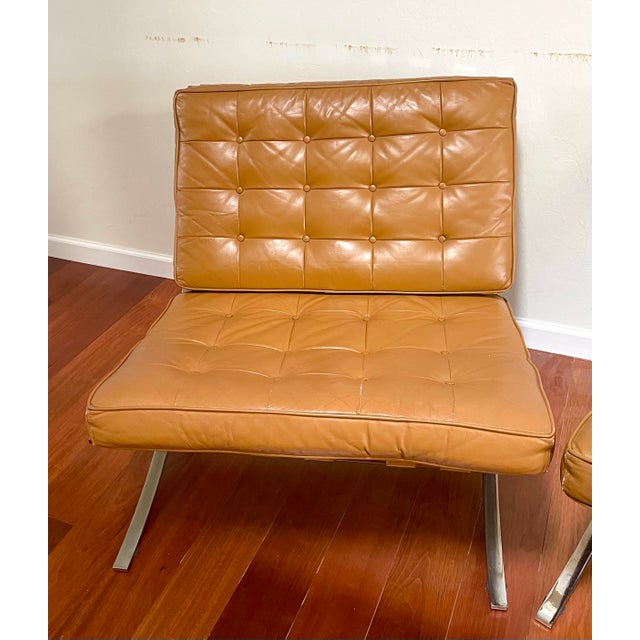 Nice pair of vintage Barcelona style lounge chairs by Selig Furniture. The chairs feature tufted yellow ochre leather...