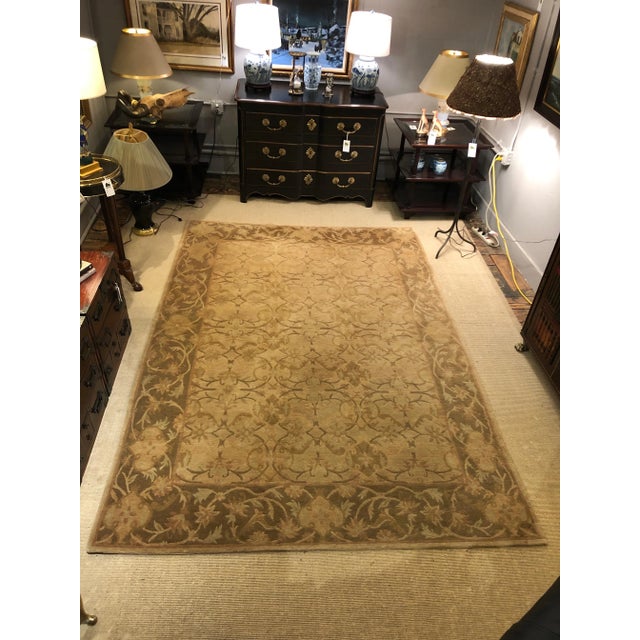 A beautiful silk Tibetan area rug in shades of camel, cream and brown with wonderful pattern.