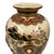 This item is a Japanese Satsuma earthenware vase, dating from the late Meiji period (1868–1912) to the early 20th century....