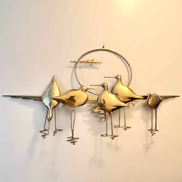 Vintage 1980s brass wall sculpture by Bijan Bahar featuring elegant Nantucket sandpipers or shorebirds silhouetted against...