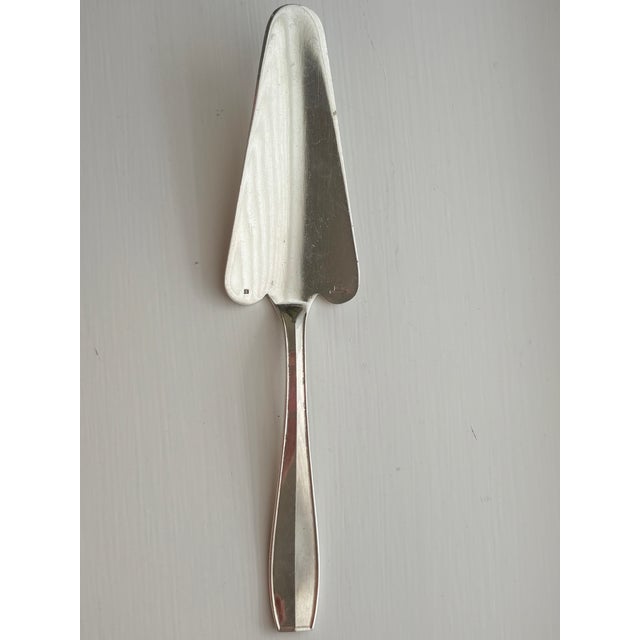 Silverplated pie or cake server by Christofle. Wide, trowel shaped blade with a scalloped edge, with a slim straight...