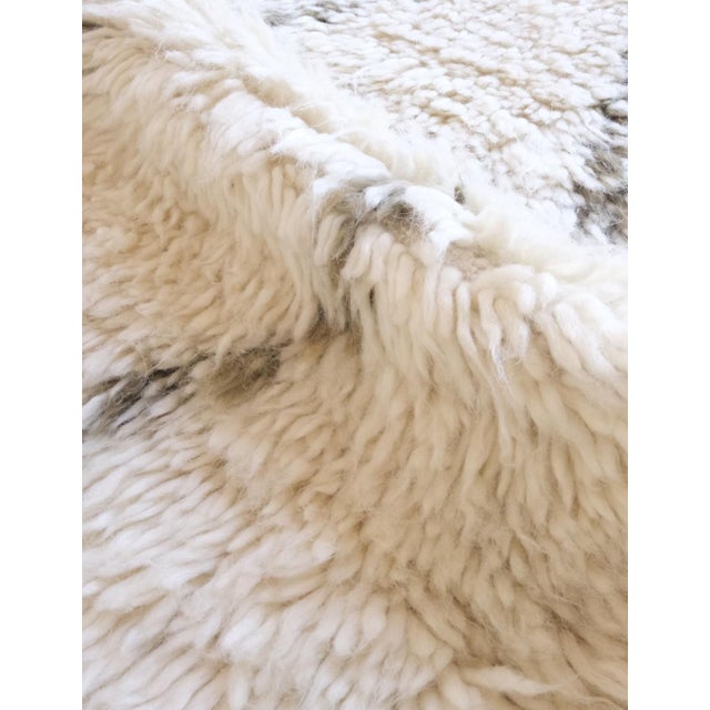 Add a touch of understated elegance to your home with the Marmoucha Moroccan Wool Rug. Measuring 7.2 by 6 feet, this...