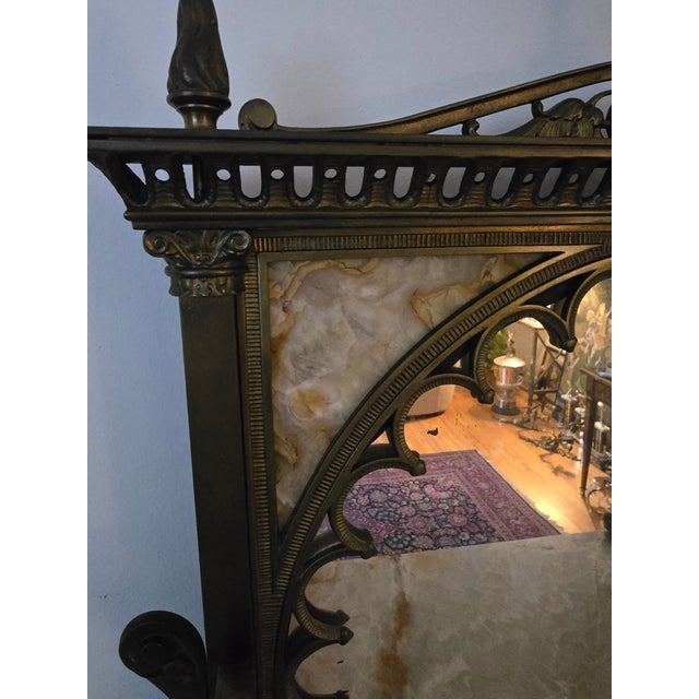 A very fine and rare pre mid century modern exotic stone and bronze etagere. Having a gilded bronze chubby angel cupid...