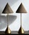 This striking pair of mid-century modern brass table lamps, by Flute of Chicago, features a sleek conical base, slender...