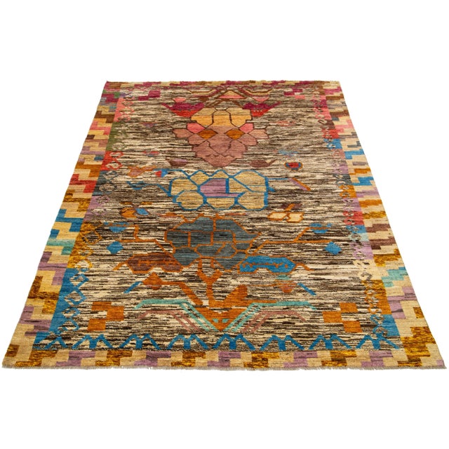 This modern Moroccan wool rug showcases a captivating Tribal pattern in a multitude of colors, adding vibrancy to any...