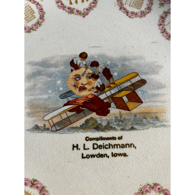 Marvelous antique 1914 calendar plate showing the moon being painted by three boys on a biplane. Gold trim. From Lowden,...