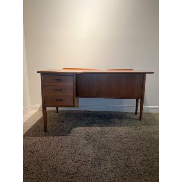 Recently restored and refinished Danish boomerang teak desk Attributed to Peter Løvig Nielsen. It features bookshelf in...
