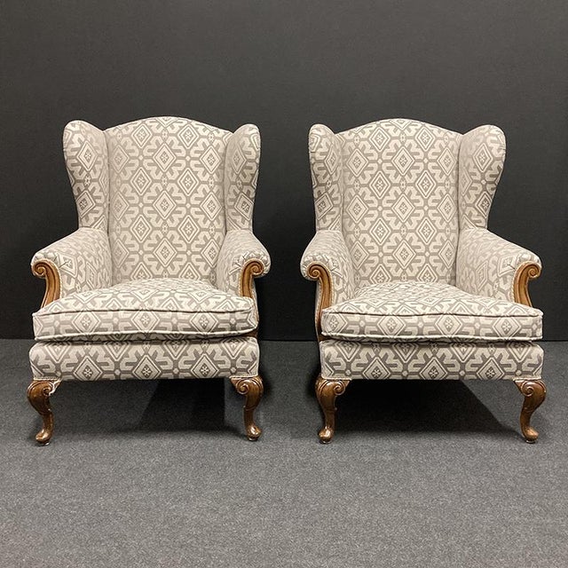 Set of three mid-20th century armchairs, with finely carved solid walnut legs and armrest details, padding completely...