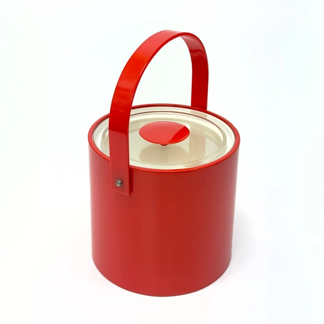Red ice bucket. This is an eccentric Georges Briard fire truck-red faux patent leather ice bucket in a cylindrical shape...