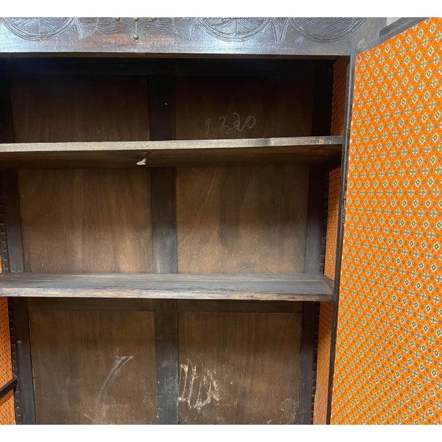 Antique solid wood wardrobe, richly carved, with doors decorated with floral and symbolic motifs. Beautiful period patina...