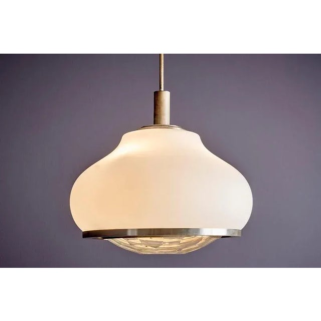 Large Italian pendant lamp in opaque glass, designed by Pia Guidetti Crippa for Lumi Milano. The glass body is finished...