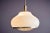 Large Italian pendant lamp in opaque glass, designed by Pia Guidetti Crippa for Lumi Milano. The glass body is finished...