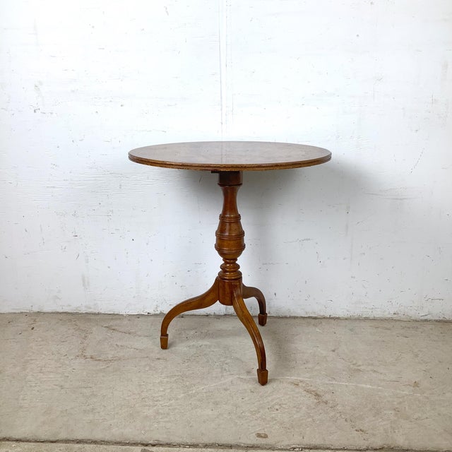 A refined pedestal accent table from the Oxford collection by Weiman, featuring a richly figured burl veneer top protected...