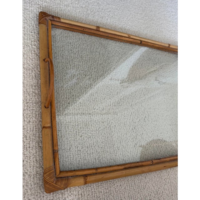 Vintage rectangular serving tray crafted from bamboo and rattan with side loop handles and a clear glass inset. mid-...