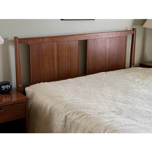 Mid-Century Modern walnut queen-size headboard featuring a clean-lined design with sculpted uprights, rich walnut grain,...