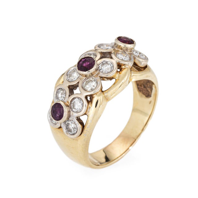 Stylish ruby & diamond flower band (circa 1970s to 1980s) crafted in 14k yellow gold. 12 diamonds total an estimated 0.96...