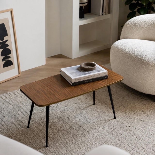 This 1960s side table boasts a perfectly sharp silhouette. The stark, mechanical lines of four tapered black legs,...