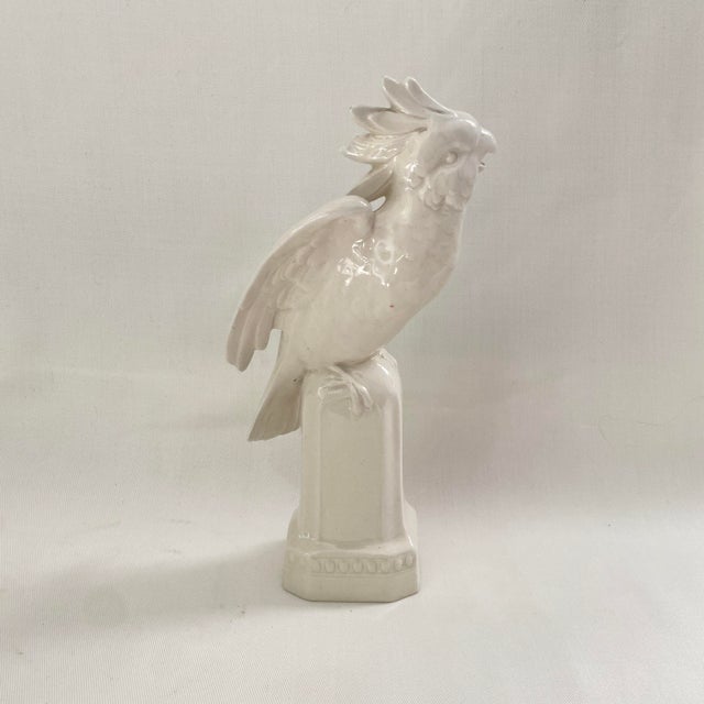 Vintage White Glazed Ceramic Sculpture of a Parrot sitting on a pedestal