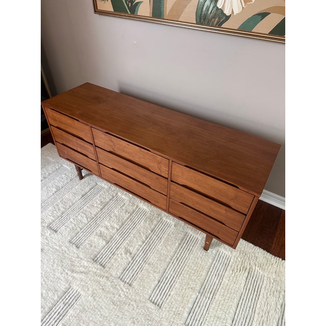 Beautiful walnut mid century 9-drawer dresser made by Stanley Furniture Company in the 1950s. Features a bank of 3 smaller...
