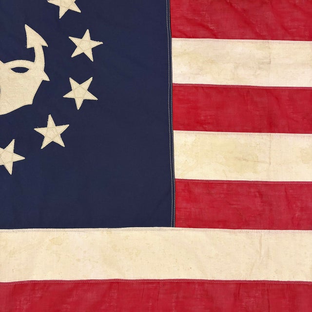 This modified vintage flag is made from a thin cotton cloth and newly embellished with an American yacht ensign emblem....