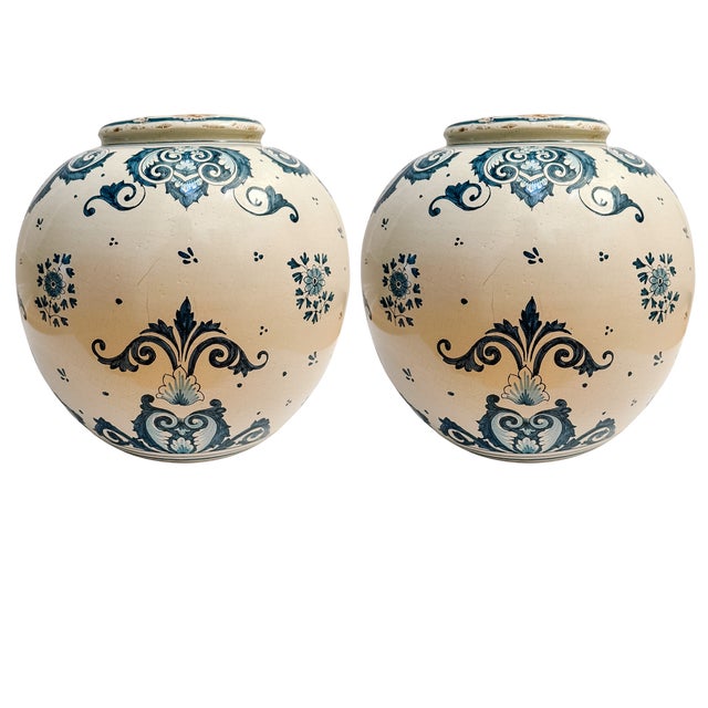 A magnificent pair of oversized jars capturing the elegance of Italian Renaissance-revival ceramic artistry. These globose...