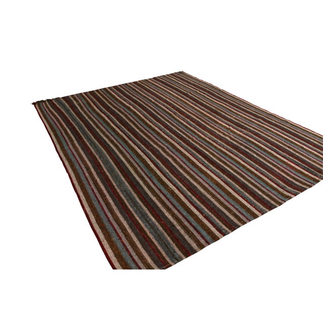 Hand woven in wool originating from Turkey between 1950-1960, this vintage mid-century Kilim enjoys one of the most subtle...