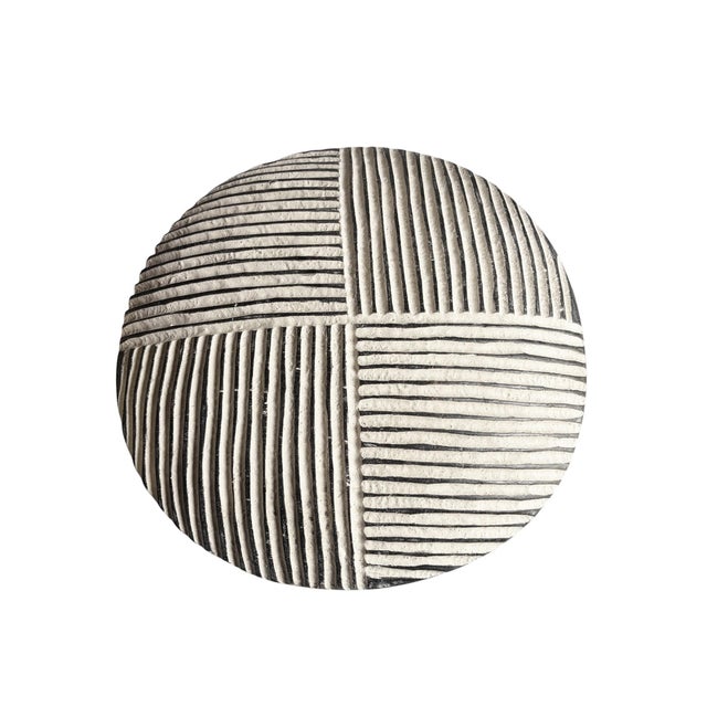 A Vintage hand-carved shield from the Bamileke people of Cameroon, from a single piece of wood. This striking round shield...