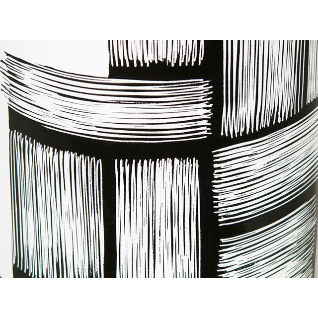 A Black & white umbrella stand made of enameled copper. light defects on the base This piece is attributed to the...