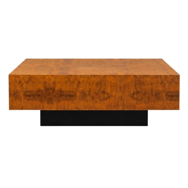 This is a modern burl walnut veneered plinth style coffee table. The base is painted black. The body is a Burl veneer. It...