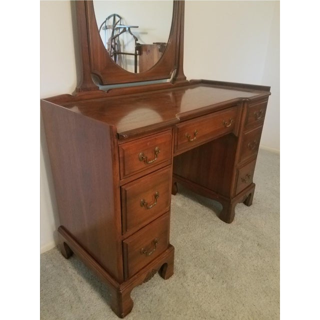 Gorgeous walnut vanity with mirror in excellent condition. Made by the Davis Cabinet Co. in Nashville, Tennessee in 1941....