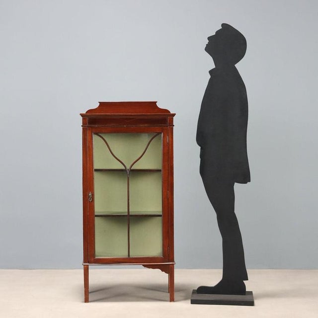 Art Nouveau mahogany display cabinet. Blown glass on the front and sides. Interior features a pair of shelves, accessible...