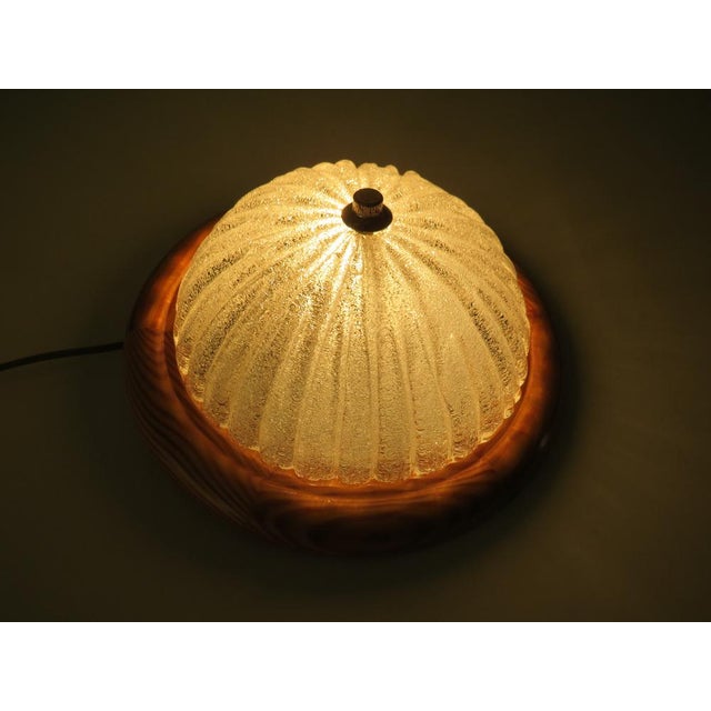 The lamps have a round pine wooden wall plate on which a half glass ribbed sphere of glass, with ice glass effect is...