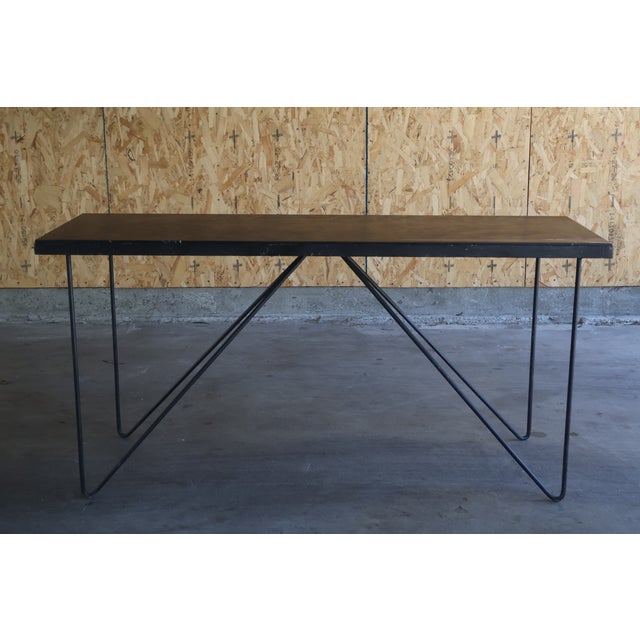 A vintage mid-century 1950s iron console table with black marble top, California. In good condition with patina to the...