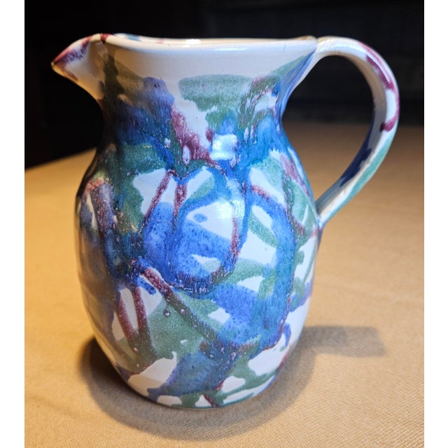This signed pitcher was crafted by Evin Jason (EJ) King (1931–2010), a sixth-generation potter from Seagrove, North...