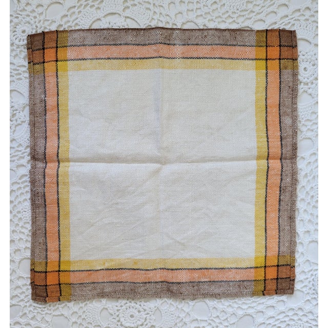 A set of yellow, orange, brown and ivory cocktail napkins. They are linen and measure 11 ½” square. This set of four is...