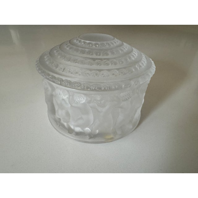 This crystal box was originally created in 1931 by Rene’ Lalique, depicts a band of children the encircle the exterior of...