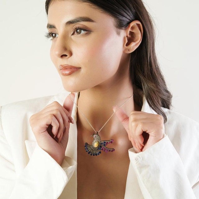 This exquisite brooch cum pendant is crafted in 925 sterling silver and showcases a striking natural opal at the center,...