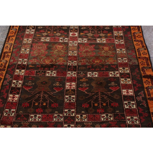 Hand woven in wool originating from Afghanistan circa 1950-1960, this vintage Kilim connotes a mid-century adaptation of a...
