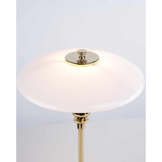 Ph 2/1 table lamp designed by poul henningsen and introduced in this version by louis poulsen in 2019. The lamp is made...