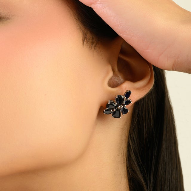 These charming vintage-inspired stud earrings are crafted in solid silver and designed in a graceful floral cluster motif....