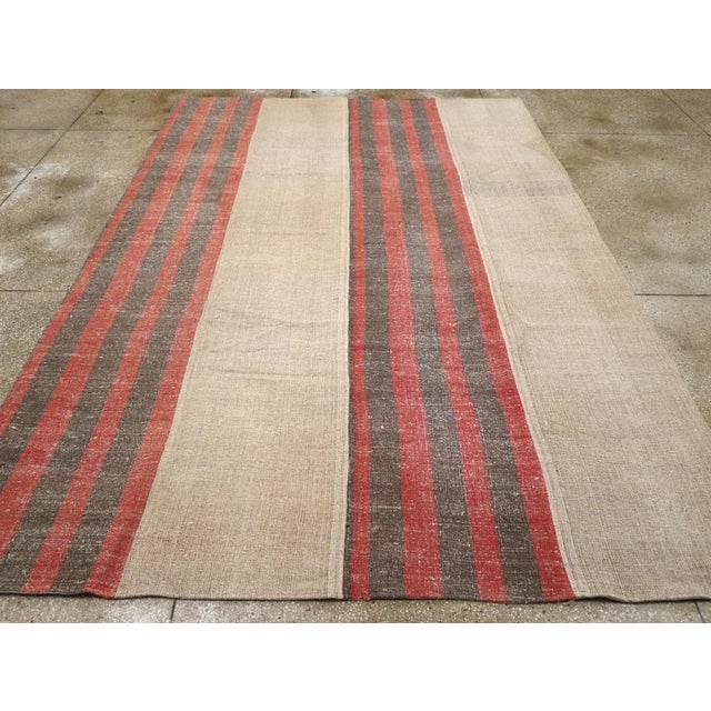 A vintage Turkish flatweave Kilim room Size carpet handmade during the Mid-20th Century. Measures: 8' 5" x 12' 1".